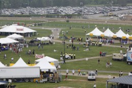 People mill about the infield before the 134th running of the Preakness Stakes horse race at Pimlico Race Course on Saturday, May 16, 2009, in Baltimore. (AP Photo/Matt Rourke)