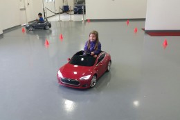 Kids take the Tesla Model S for Kids for a “road test” at Tesla Motors Tyco Road in Vienna, Va. on Sunday, May 22, 2016. (WTOP/Kathy Stewart)