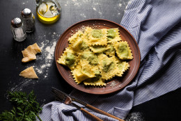 classic ravioli on a plate with cutlery. Italian dumplings. Heal