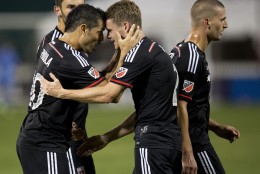 D.C. United forward Fabian Espindola (10) and teammate defender Taylor Kemp (2) celebrate after teammate Perry Kitchen, right, scored during the second half of an MLS soccer match against the Real Salt Lake in Washington, Saturday, Aug. 1, 2015. D.C. United won 6-4.    (AP Photo/Manuel Balce Ceneta)