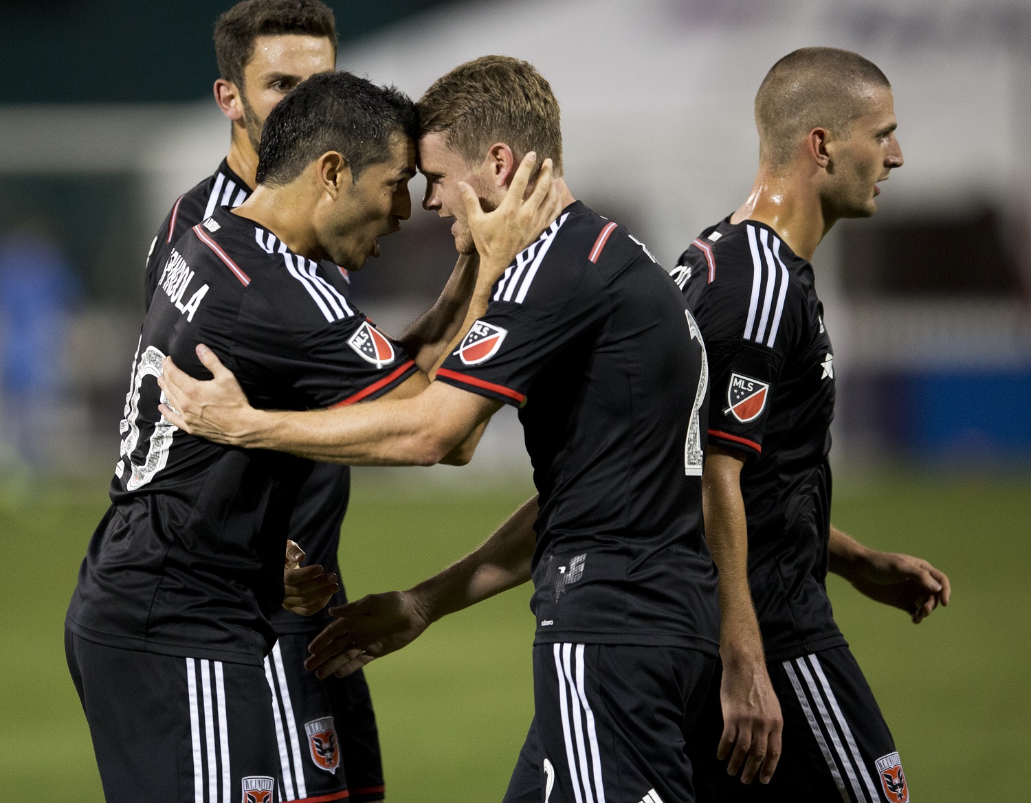 D.C. United forward Fabian Espindola (10) and teammate defender Taylor Kemp (2) celebrate after teammate Perry Kitchen, right, scored during the second half of an MLS soccer match against the Real Salt Lake in Washington, Saturday, Aug. 1, 2015. D.C. United won 6-4.    (AP Photo/Manuel Balce Ceneta)