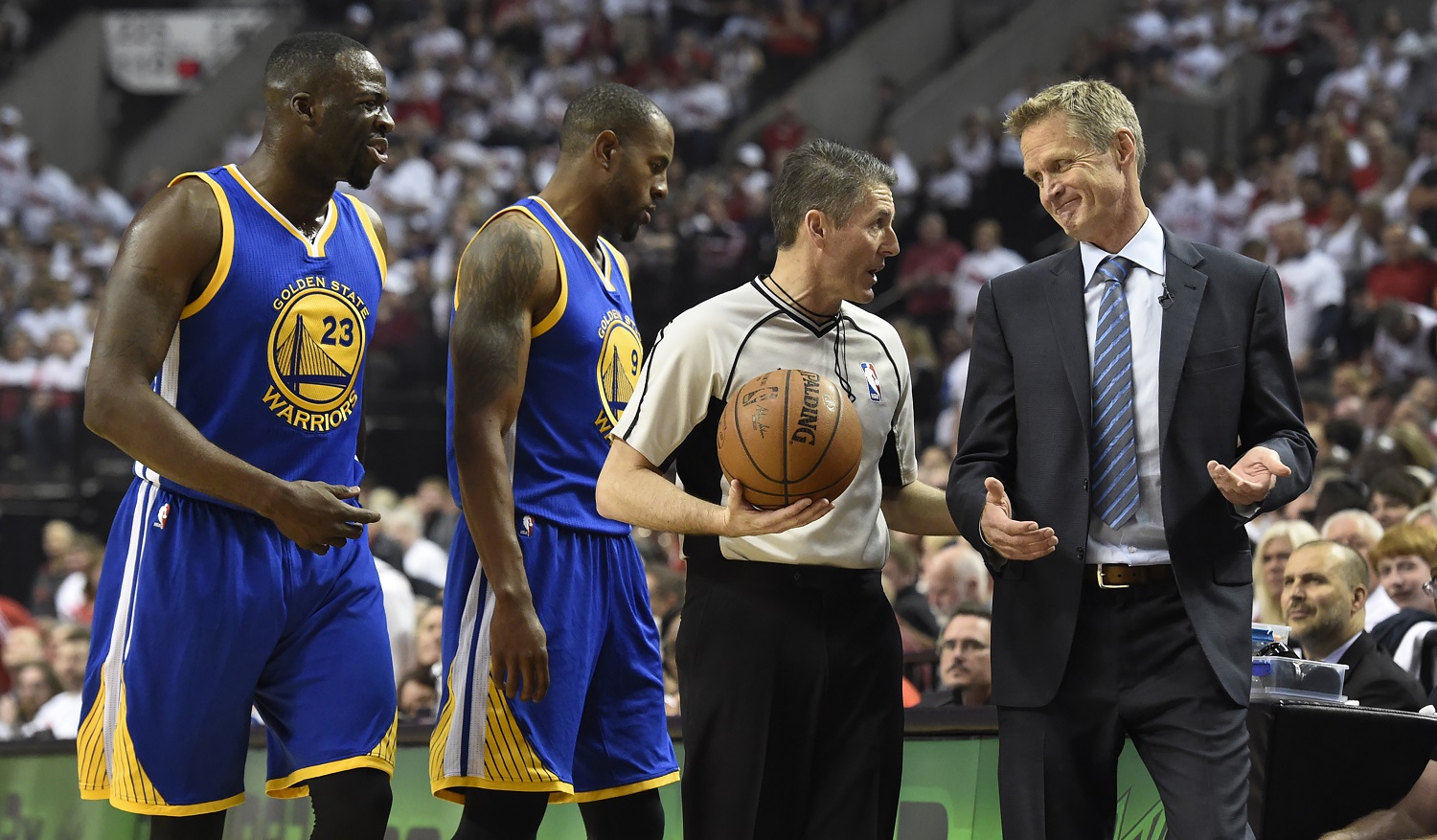 PORTLAND, OR - MAY 9: Draymond Green, Andre Iguodala #9 and head coach Steve Kerr of the Golden State Warriors have some words with referee Scott Foster #48 during the first quarter of Game Four of the Western Conference Semifinals against the Portland Trail Blazers during the 2016 NBA Playoffs at the Moda Center on May 9, 2016 in Portland, Oregon. NOTE TO USER: User expressly acknowledges and agrees that by downloading and/or using this photograph, user is consenting to the terms and conditions of the Getty Images License Agreement.  (Photo by Steve Dykes/Getty Images)