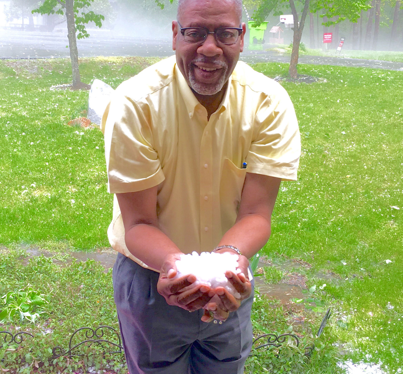 "No, this is not snow." WTOP listener Charles Penn scoops up some hail in Manassas, Virginia around 6:20 p.m. Monday. (Courtesy Charles Penn)