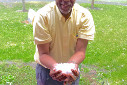 "No, this is not snow." WTOP listener Charles Penn scoops up some hail in Manassas, Virginia around 6:20 p.m. Monday. (Courtesy Charles Penn)