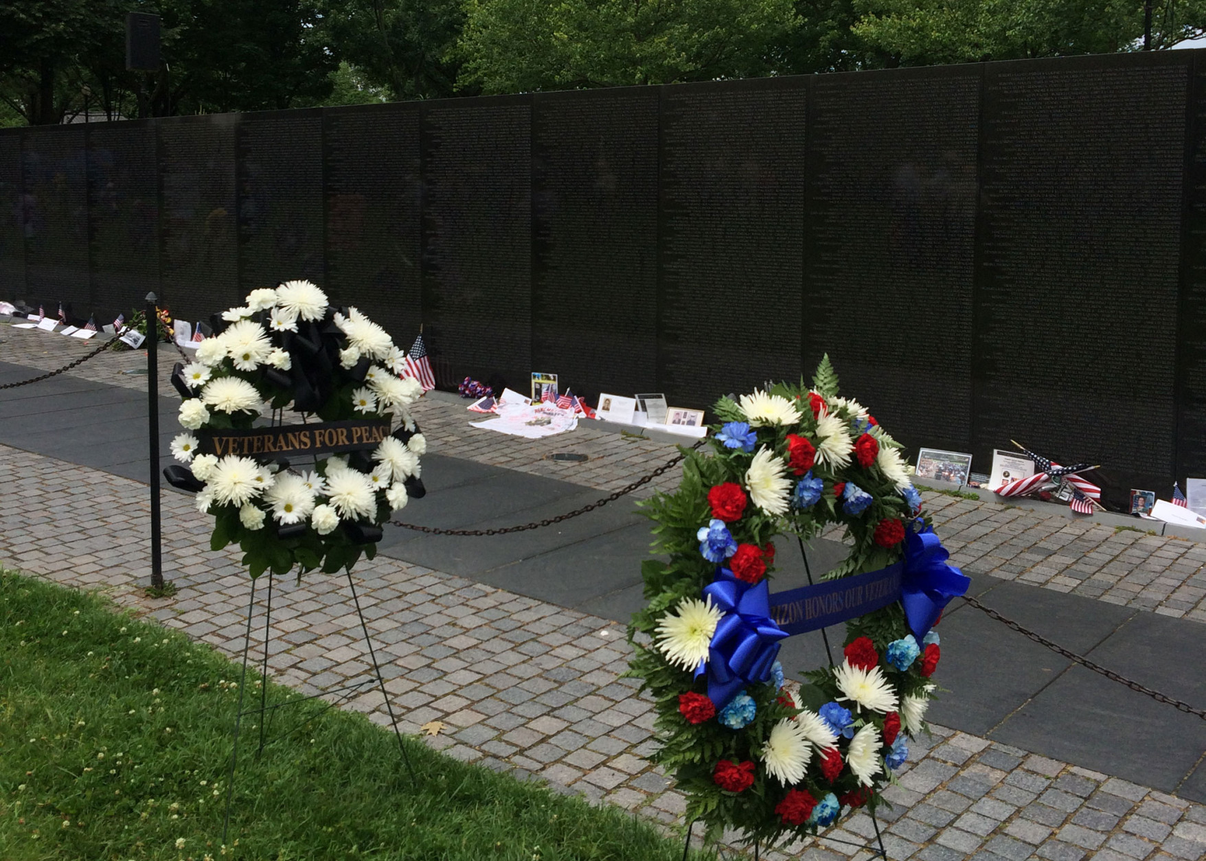 Floral wreaths rest next to the Vietnam Veterans Memorial. A ceremony to honor those who lost their lives during the Vietnam War was held at the memorial Monday. (WTOP/Dick Uliano)