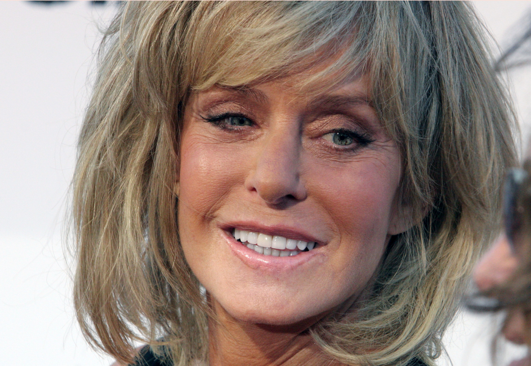 FILE - In this Aug. 13, 2006 file photo, actress Farrah Fawcett poses for photographers on the red carpet before Comedy Central's "Roast of William Shatner,"  in Los Angeles. Fawcett died, Thursday, June 25, 2009, at a hospital in Los Angeles.  She was 62. (AP Photo/Rene Macura, file)