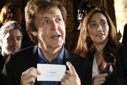 Sir Paul McCartney shows his pass next to his fiance Nancy Shevell during his daughter Stella McCartney's spring-summer 2012 ready-to-wear collection presented Monday, Oct.3, 2011 in Paris.  (AP Photo/Thibault Camus)