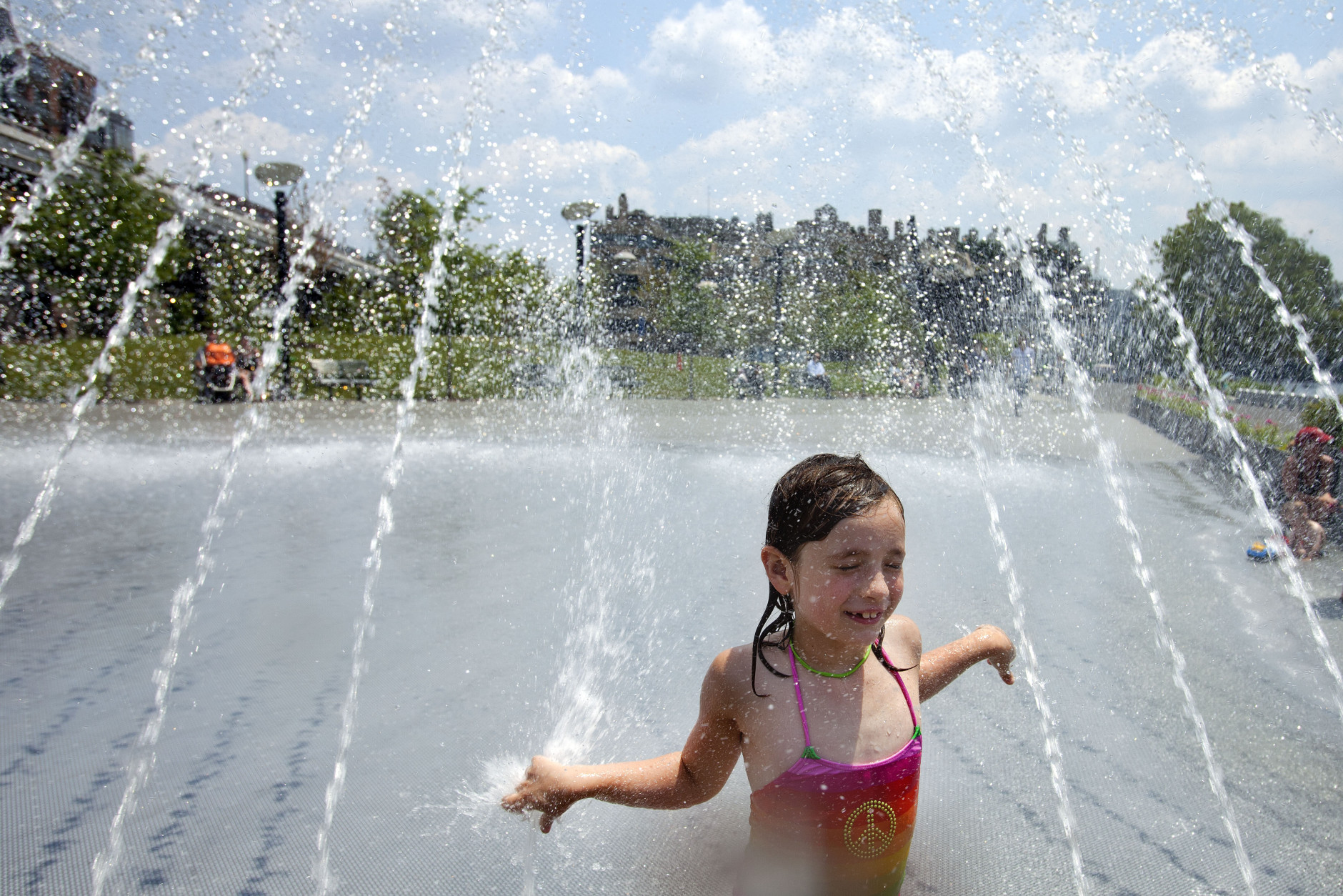 Sophia Tatton, 7, of Washington, cools off  in the fountains at Georgetown Waterfront Park, in Washington, on Wednesday, June 20, 2012. Temperatures across the Northeast are expected to approach triple digits. (AP Photo/Jacquelyn Martin)