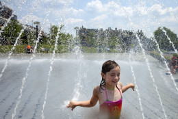 Sophia Tatton, 7, of Washington, cools off  in the fountains at Georgetown Waterfront Park, in Washington, on Wednesday, June 20, 2012. Temperatures across the Northeast are expected to approach triple digits. (AP Photo/Jacquelyn Martin)