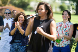 First lady Michelle Obama, flanked by Rachel Ray, left, and Let's Move! Executive Director Deb Eschmeyer, right, welcomes school children from across the country to harvest the White House Kitchen Garden, Monday, June 6, 2016, at the White House in Washington. (AP Photo/Andrew Harnik)