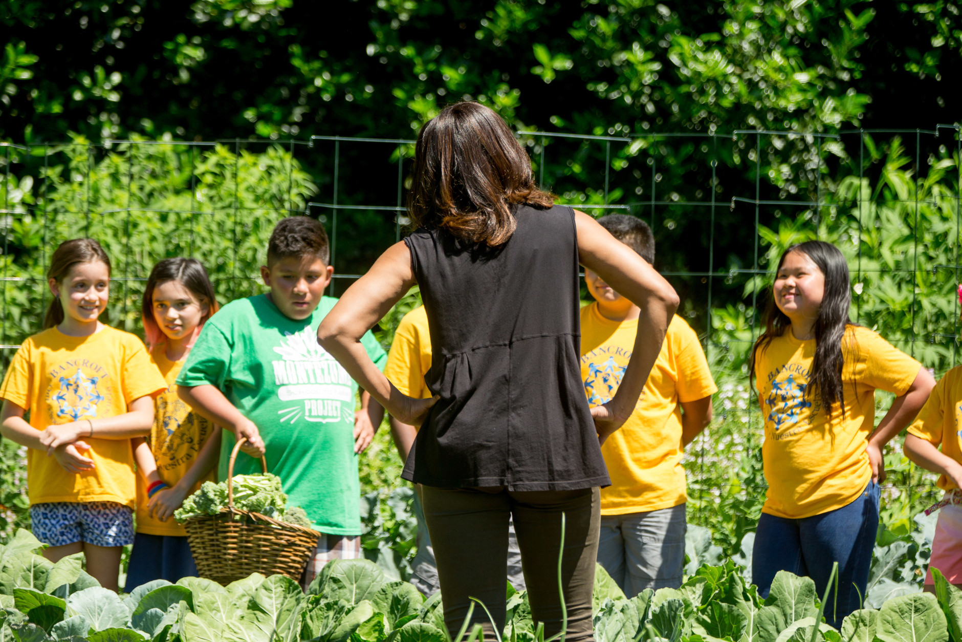 First lady Michelle Obama speaks to school children from across the country as they harvest the White House Kitchen Garden, Monday, June 6, 2016, at the White House in Washington. (AP Photo/Andrew Harnik)