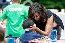 First lady Michelle Obama speaks with a child as school children from across the country help harvest the White House Kitchen Garden, Monday, June 6, 2016, at the White House in Washington. (AP Photo/Andrew Harnik)