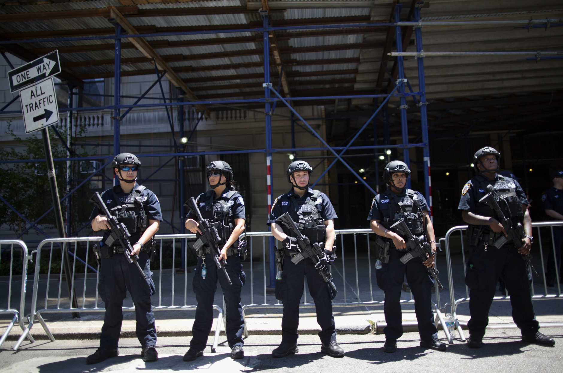 Heavily armed police officers stand guard near a news conference by Chief James R. Waters, New York Police Dept. Chief of Counterterrorism and Mayor Bill de Blasio on Sunday, June 12, 2016, in New York. Waters and Blasio were briefing reporters on NY's reaction and preparedness in response to early Sunday's Florida gay nightclub shooting. (AP Photo/Mary Altaffer)