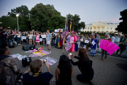 John Becker, center, speaks to fellow members and supporters of the LGBT as they gather for a candlelight vigil in front of the White House in Washington, Sunday, June 12, 2016, in support for the victims and their families and friends, who were killed and injured in a massacre at an Orlando nightclub. (AP Photo/Manuel Balce Ceneta)
