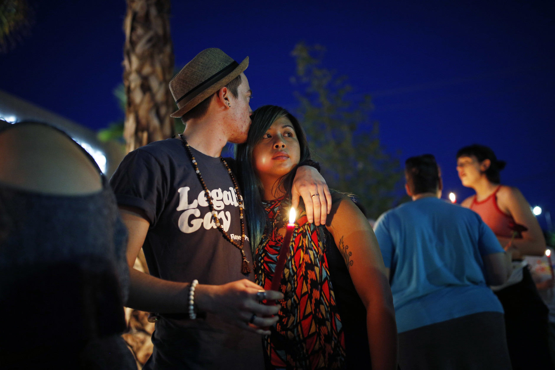 Two people embrace during a vigil at The Center, a community center for the LGBT community, Sunday, June 12, 2016, in Las Vegas. The vigil was for the victims of the Pulse nightclub shooting in Orlando. (AP Photo/John Locher)