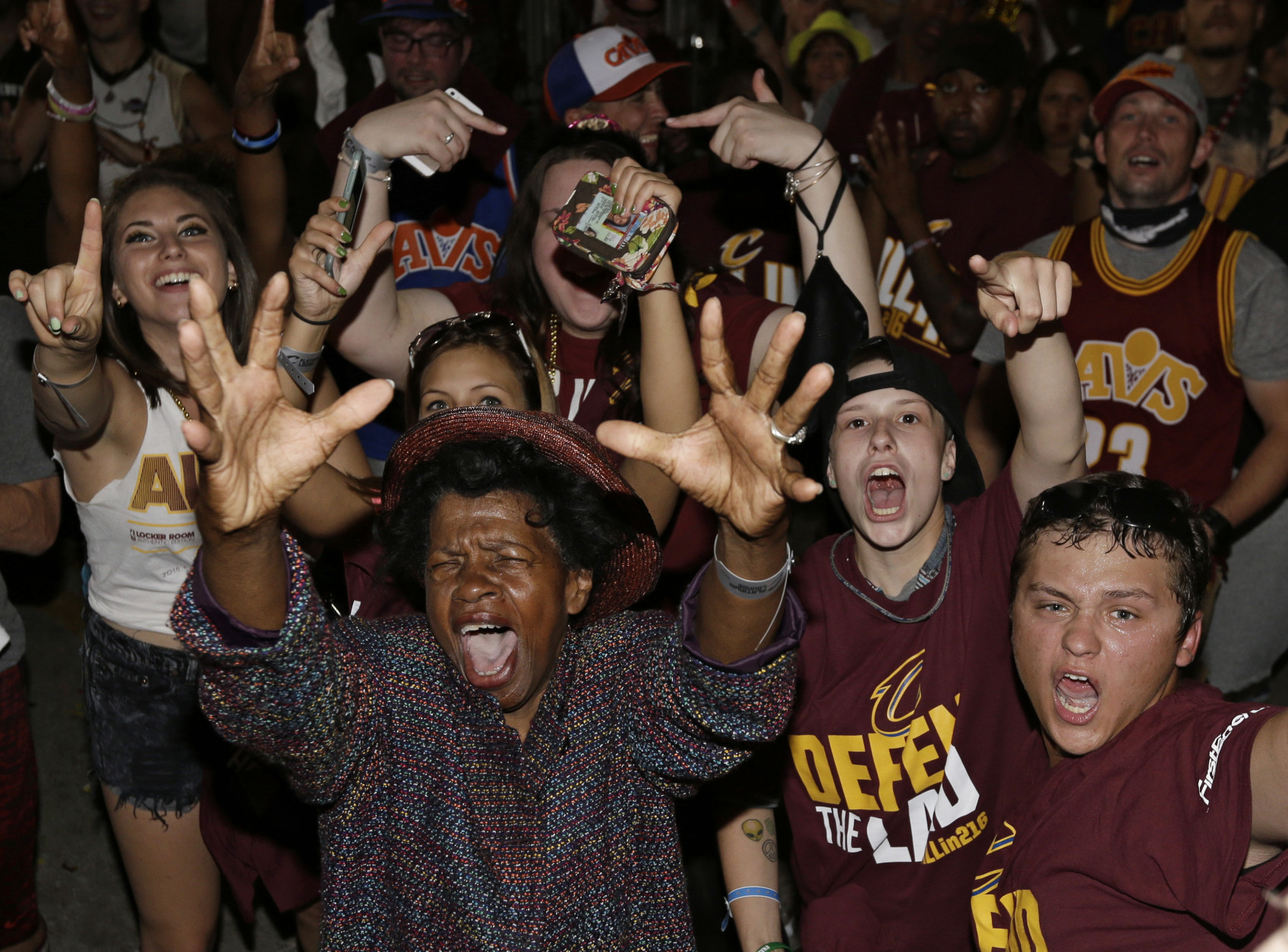 Cleveland Cavaliers fans celebrate after the Cavaliers defeated the Golden State Warriors 93-89 in Game 7 of the NBA basketball Finals, Sunday, June 19, 2016, in Cleveland. (AP Photo/Tony Dejak)