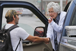 Rainelle W.Va. Mayor, Andrea Pendleton, right, talks to resident Nicholas Remick as she tours the flooded streets of Rainelle, W. Va., Saturday, June 25, 2016. Heavy rains that pummeled West Virginia left multiple people dead, and authorities said Saturday that an unknown number of people in the hardest-hit county remained unaccounted for.  (AP Photo/Steve Helber)