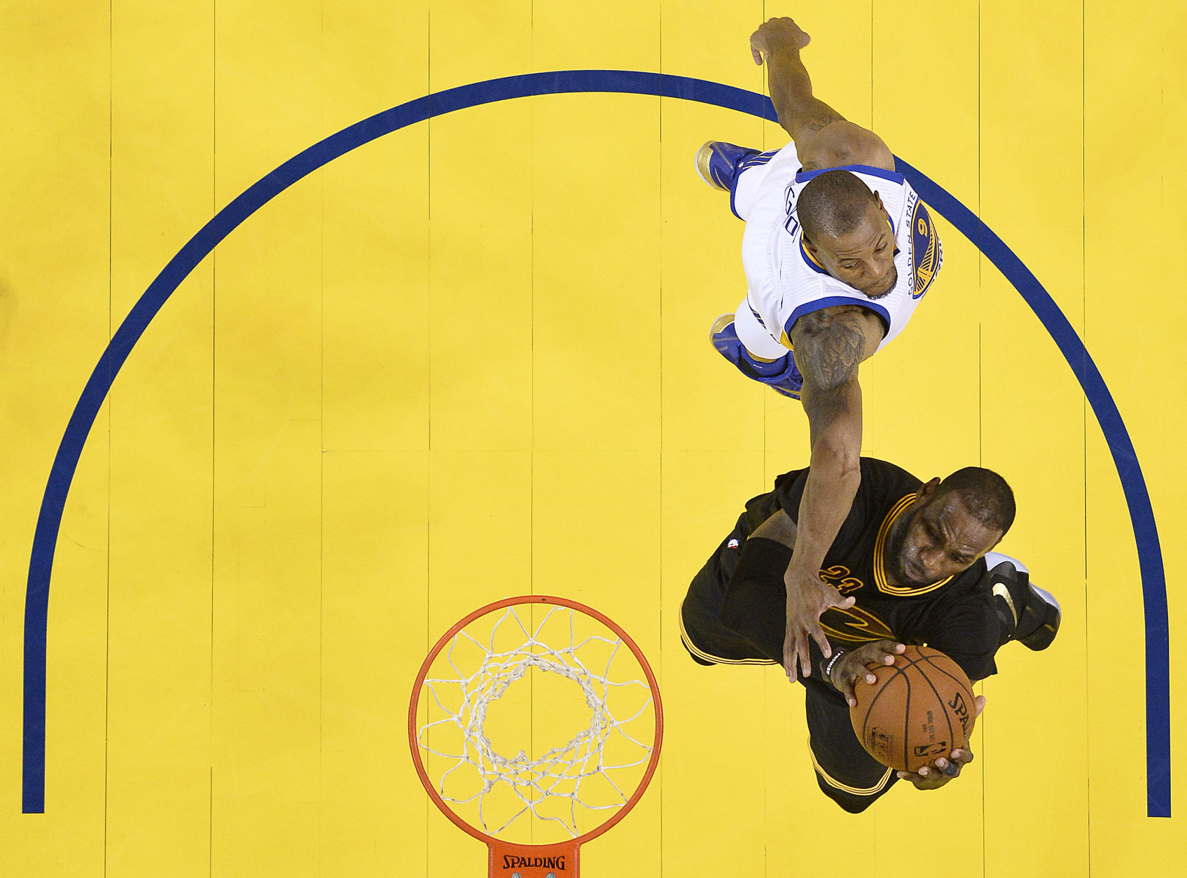 Cleveland Cavaliers forward LeBron James, bottom, shoots against Golden State Warriors forward Andre Iguodala during the second half of Game 7 of basketball's NBA Finals in Oakland, Calif., Sunday, June 19, 2016. The Cavaliers won 93-89. (John G. Mabanglo, European Pressphoto Agency via AP, Pool)