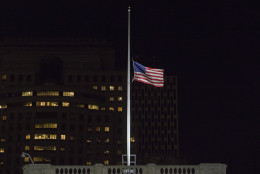 The American flags that fly over the New York City Hall building is lowered to half-staff in honor of the victims of the mass shooting in Orlando, Florida, in New York, Sunday, June 12, 2016. A gunman wielding an assault-type rifle and a handgun opened fire inside a crowded gay nightclub early Sunday before dying in a gunfight with SWAT officers. (AP Photo/Andres Kudacki)