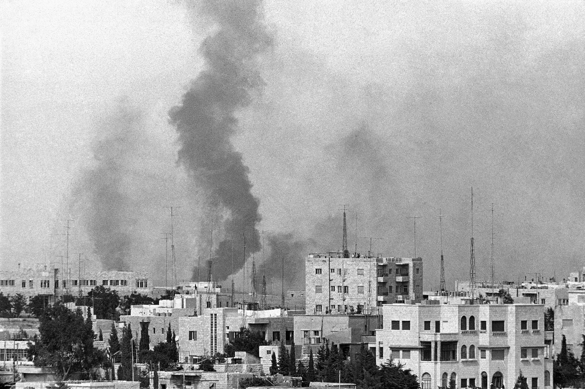 Smoke billows skyward over Amman, Jordan, June 8, 1967 after the June 5 Israeli air raid on the city. (AP Photo/Freye)