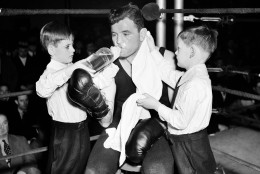 James J. Braddock, heavyweight champion, is working out at Stillmans Gym and was helped  by his two sons Jay, left, and Howard, Jan. 27, 1937 in New York. (AP Photo)