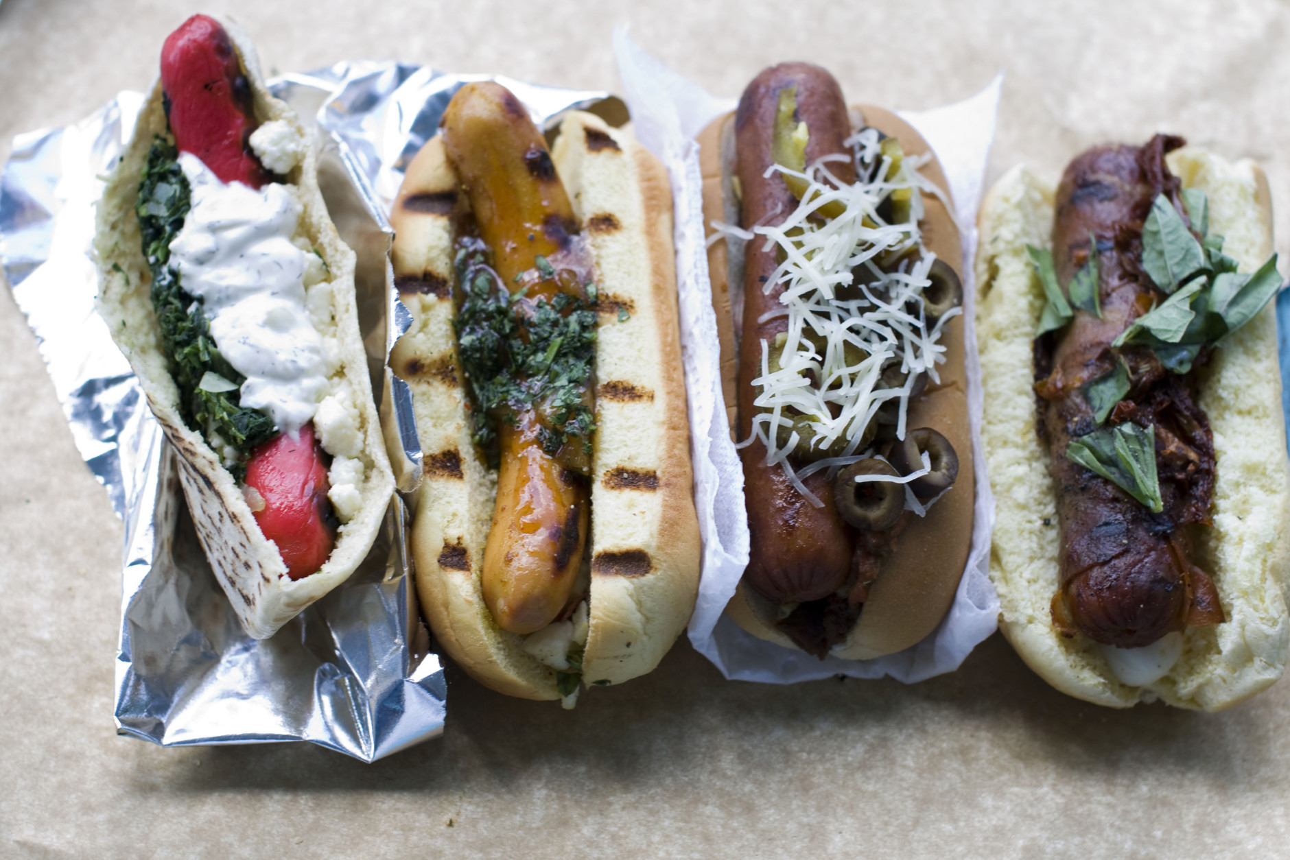 In this image taken on July 30, 2012, hot dogs, from left, Greek spanakopita, Indian curry, taco and pizza are shown in Concord, N.H. (AP Photo/Matthew Mead)