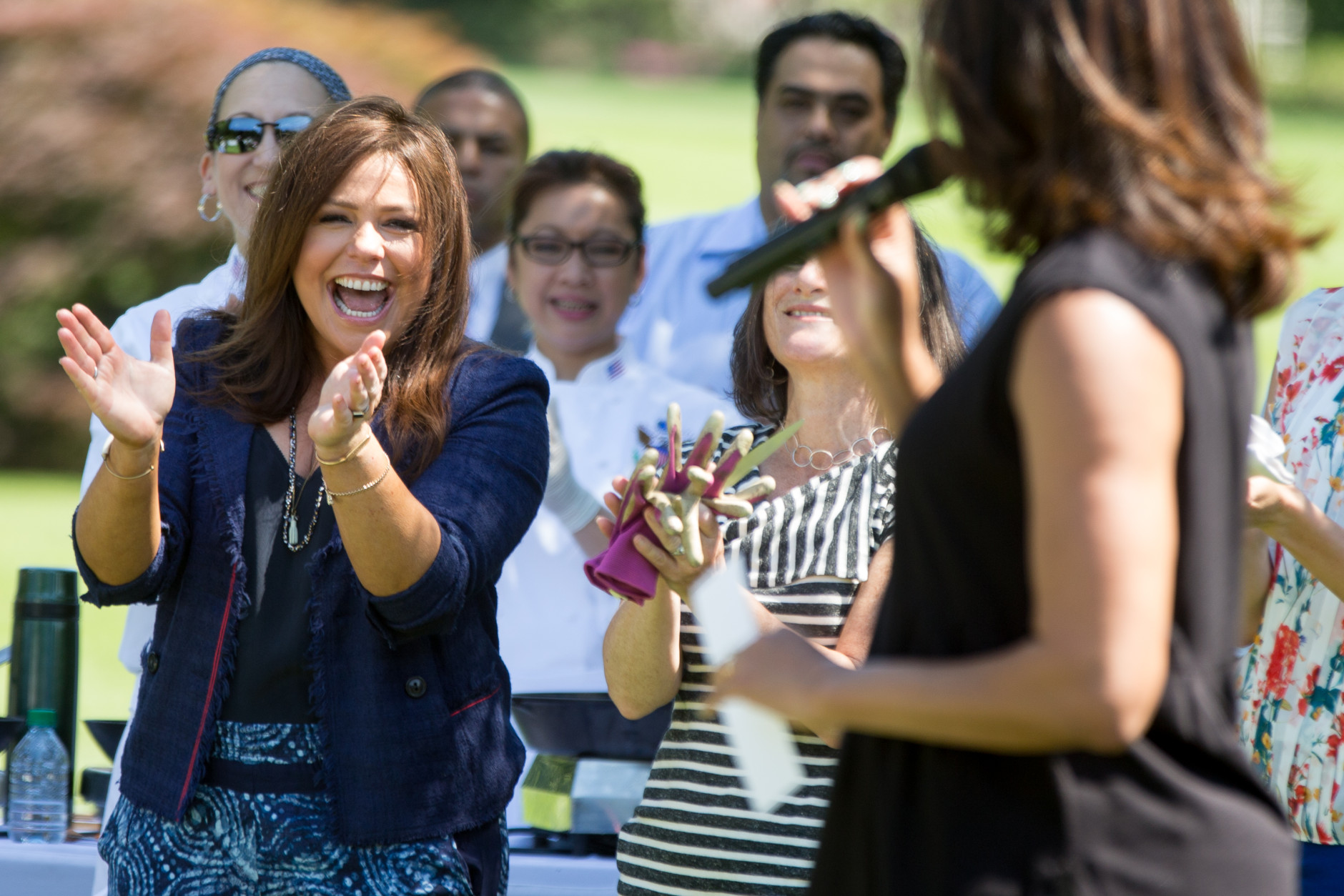 First lady Michelle Obama, foreground, joined by Rachael Ray, left, welcomes school children from across the country to harvest the White House Kitchen Garden, Monday, June 6, 2016, at the White House in Washington. (AP Photo/Andrew Harnik)