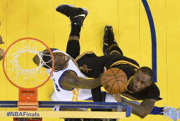 Cleveland Cavaliers forward LeBron James, right, shoots against Golden State Warriors forward Draymond Green during the second half of Game 7 of basketball's NBA Finals in Oakland, Calif., Sunday, June 19, 2016. The Cavaliers won 93-89. (John G. Mabanglo, European Pressphoto Agency via AP, Pool)