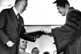 Secretary of State George C. Marshall, left, receives an honorary degree of Doctor of Laws June 5,1947 from Dr. Reginal Fitz, Harvard University marshal.  Presentation to the former Army Chief of Staff took place at university commencement ceremonies at Cambridge, Mass. Gen. Omar N. Bradley, veterans admnistrator, also a degree receipient, is in background next to Marshall. (AP Photo)