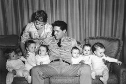 Singer-actor Elvis Presley is shown with six babies who appear in the movie "G.I. Blues" and co-star Juliet Prowse, left, on a set in Hollywood, Ca., on June 27, 1960.  The babies are three sets of twins who double for one another in the movie.  (AP Photo)