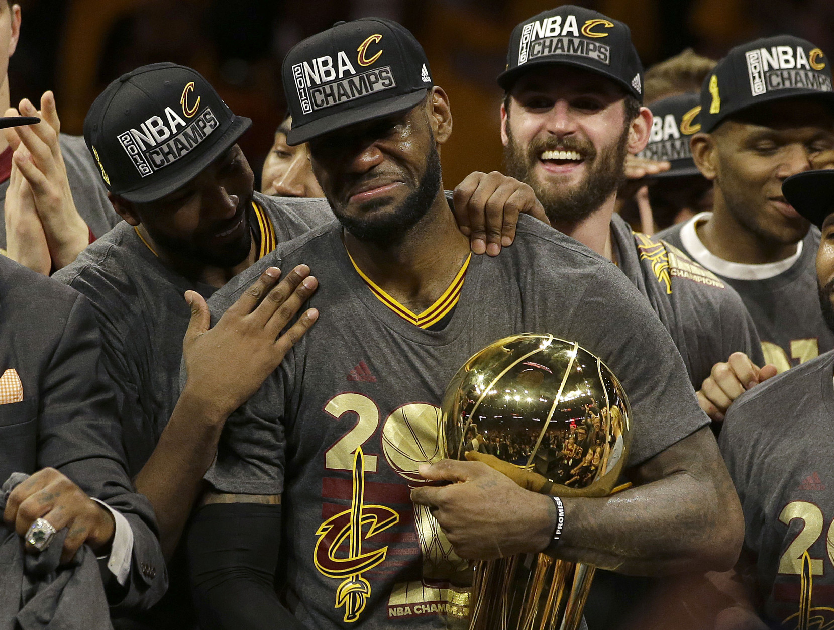 Cleveland Cavaliers forward LeBron James, center, celebrates with teammates after Game 7 of basketball's NBA Finals against the Golden State Warriors in Oakland, Calif., Sunday, June 19, 2016. The Cavaliers won 93-89. (AP Photo/Marcio Jose Sanchez)