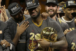 Cleveland Cavaliers forward LeBron James, center, celebrates with teammates after Game 7 of basketball's NBA Finals against the Golden State Warriors in Oakland, Calif., Sunday, June 19, 2016. The Cavaliers won 93-89. (AP Photo/Marcio Jose Sanchez)