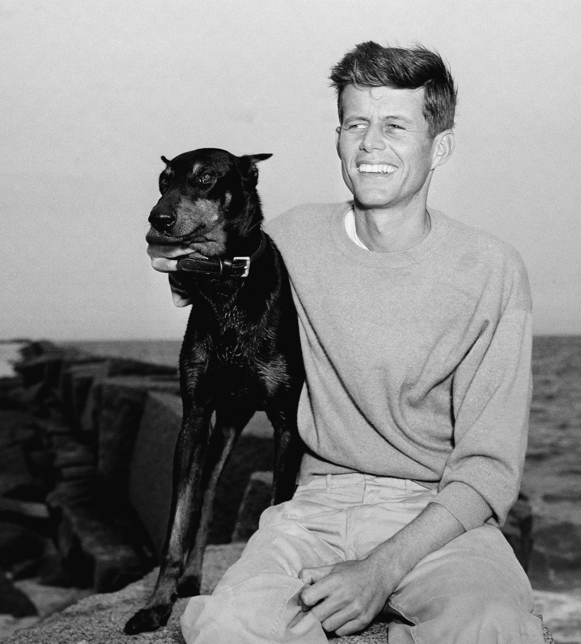 John F. Kennedy, winner of the Democratic Nomination for Congress in the 11th Massachusetts District, relaxes with his dog, Mo, June 22, 1946, Hyannisport, Mass. (AP Photo/Peter J. Carroll)