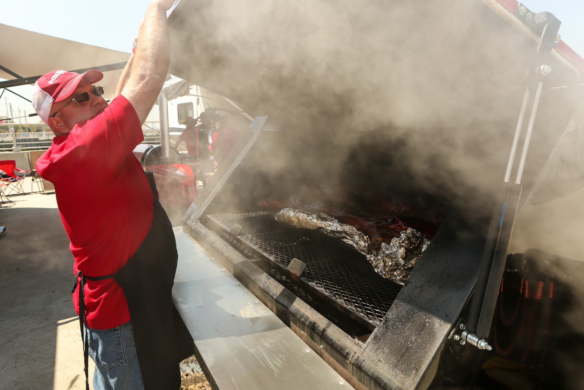 IMAGE DISTRIBUTED FOR KINGSFORD - Rescue Smokers team captain Robby Royal prepares his "Pick Your Pork" entry during the Kingsford Invitational on Saturday, May 2, 2015 at Hudson River Parks Pier 26, New York. (Photo by Matt Peyton/Invision for Kingsford/AP Images)