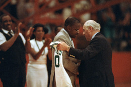 Boston Celtics' president Arnold "Red" Auerbach, right, presents a team jersey to Len Bias' father James Bias during a tribute to the late basketball star at College Park, June 24, 1986.  Bias, who was headed for a pro career in Boston, died in his University of Maryland dormitory Thursday.  (AP Photo/Bill Smith)