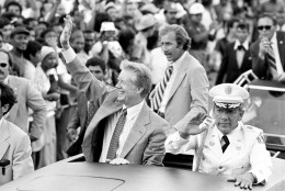 President Jimmy Carter and General Omar Torrijos wave from an open car during a motorcade Friday in Panama City, Panama, June 16, 1978. (AP Photo)