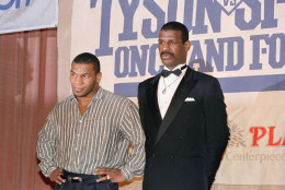 A casually-attired Mike Tyson poses with tuxedoed Michael Spinks Wednesday, March 30, 1988 in New York, where they attended news conference confirming their scheduled June 27 fight in Atlantic City, N.J., for the world heavyweight boxing title now held by Tyson. (AP Photo/ Marty Lederhandler)