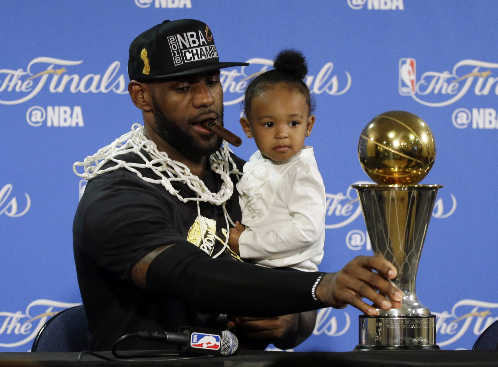 Cleveland Cavaliers' LeBron James sits down to answer questions with his daughter Zhuri during a post-game press conference after Game 7 of basketball's NBA Finals Sunday, June 19, 2016, in Oakland, Calif. Cleveland won 93-89. (AP Photo/Eric Risberg)