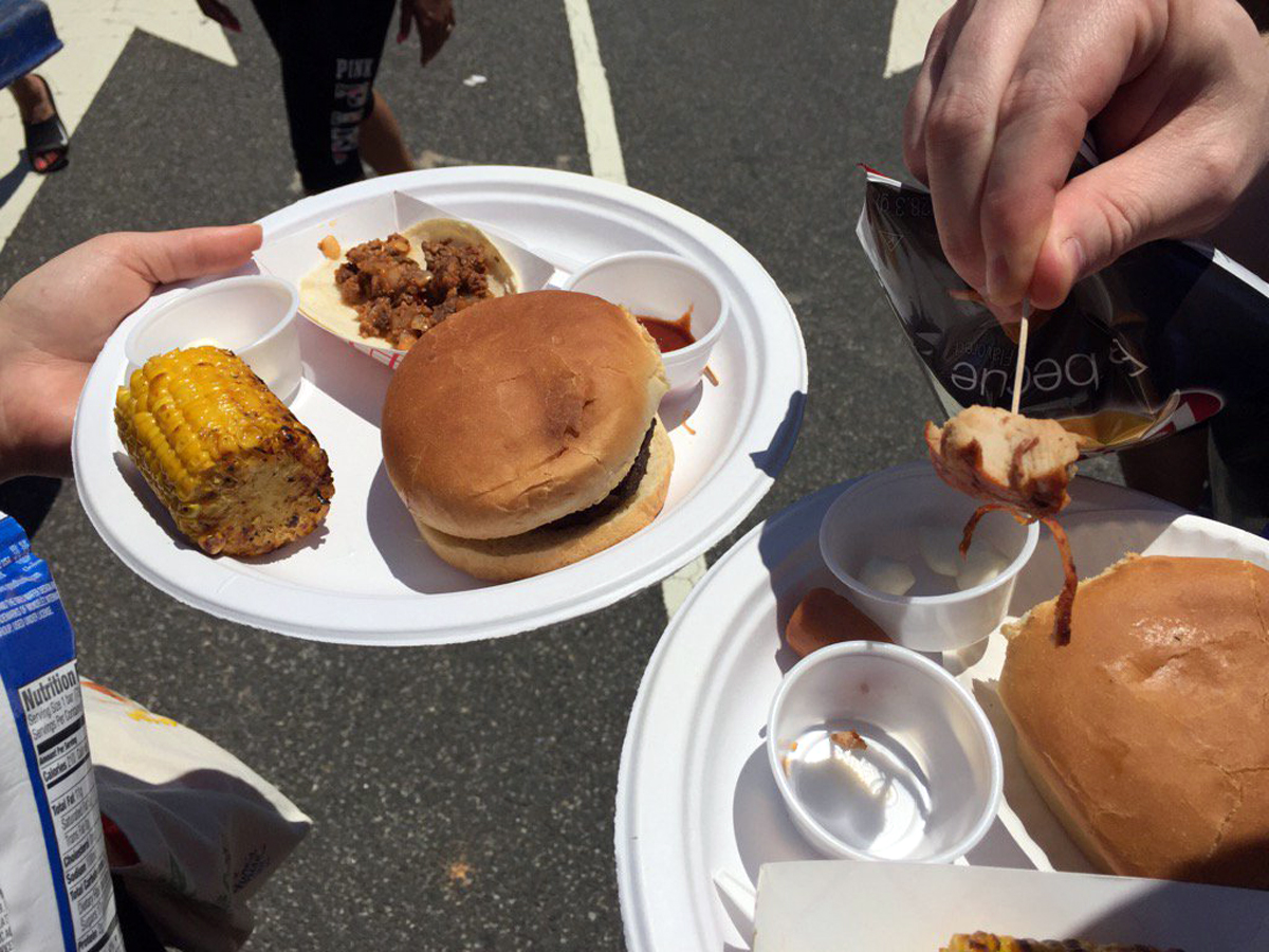 Attendees show off their plates of sample food at the Giant National Capital Barbecue Battle on Saturday in D.C. (WTOP/Kristi King)