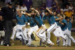 Coastal Carolina's Anthony Marks (29) reacts after sliding into home plate to score the winning run in the bottom of the ninth inning of an NCAA college baseball tournament super regional game against LSU in Baton Rouge, La., Sunday, June 12, 2016. Coastal Carolina won 4-3 to advance to the College World Series. (AP Photo/Gerald Herbert)