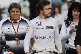 McLaren driver Fernando Alonso of Spain walks back to his team garage following a crash during the Australian Formula One Grand Prix at Albert Park in Melbourne, Australia, Sunday, March 20, 2016. (AP Photo/Ross Land)