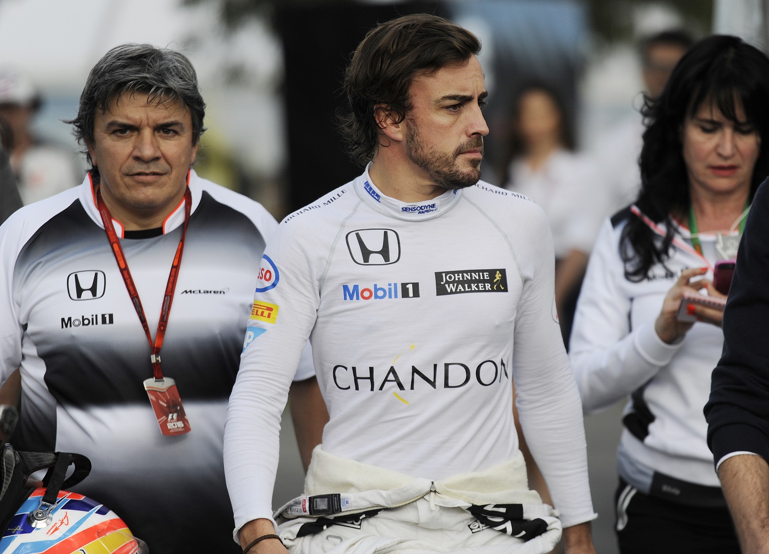 McLaren driver Fernando Alonso of Spain walks back to his team garage following a crash during the Australian Formula One Grand Prix at Albert Park in Melbourne, Australia, Sunday, March 20, 2016. (AP Photo/Ross Land)