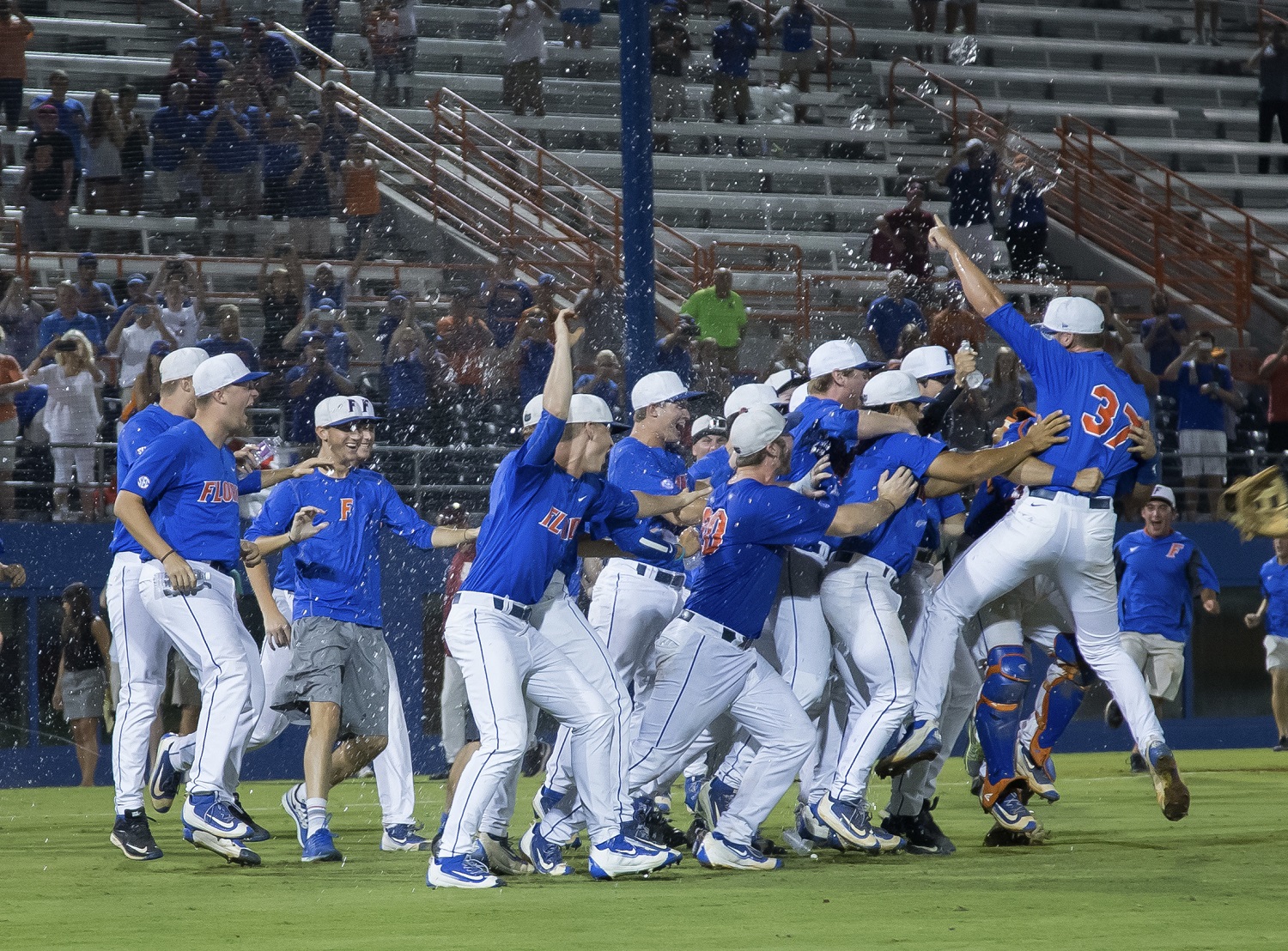 The Florida team celebrates a 7-0 win over Florida State in Game 3 of an NCAA college baseball tournament super regional in Gainesville, Fla., on Monday, June 13, 2016. (AP Photo/Ronald Irby)