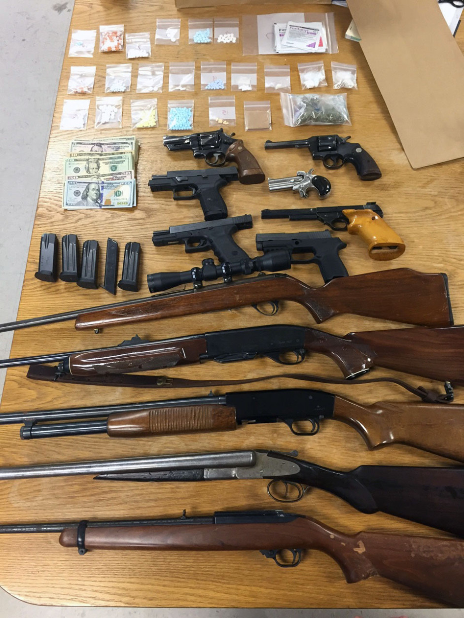 Fourteen firearms were seized in connection to a heroin ring bust in Frederick County, Md. Law enforcement uncovered more than 510 grams of the drug, a street value of about $75,000. (Courtesy Frederick County Sheriff's Office)