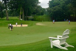 A chair sits empty looking onto the Blue course at Congressional Country Club, however crowds were roped off from accessing this area. (WTOP/Megan Cloherty)
