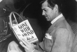 American film star Clark Gable (1901-1960) reading the novel 'Gone With the Wind' by Margaret Mitchell. His greatest role was that of Rhett Butler in the MGM film adaption of the book.   (Photo by Hulton Archive/Getty Images)