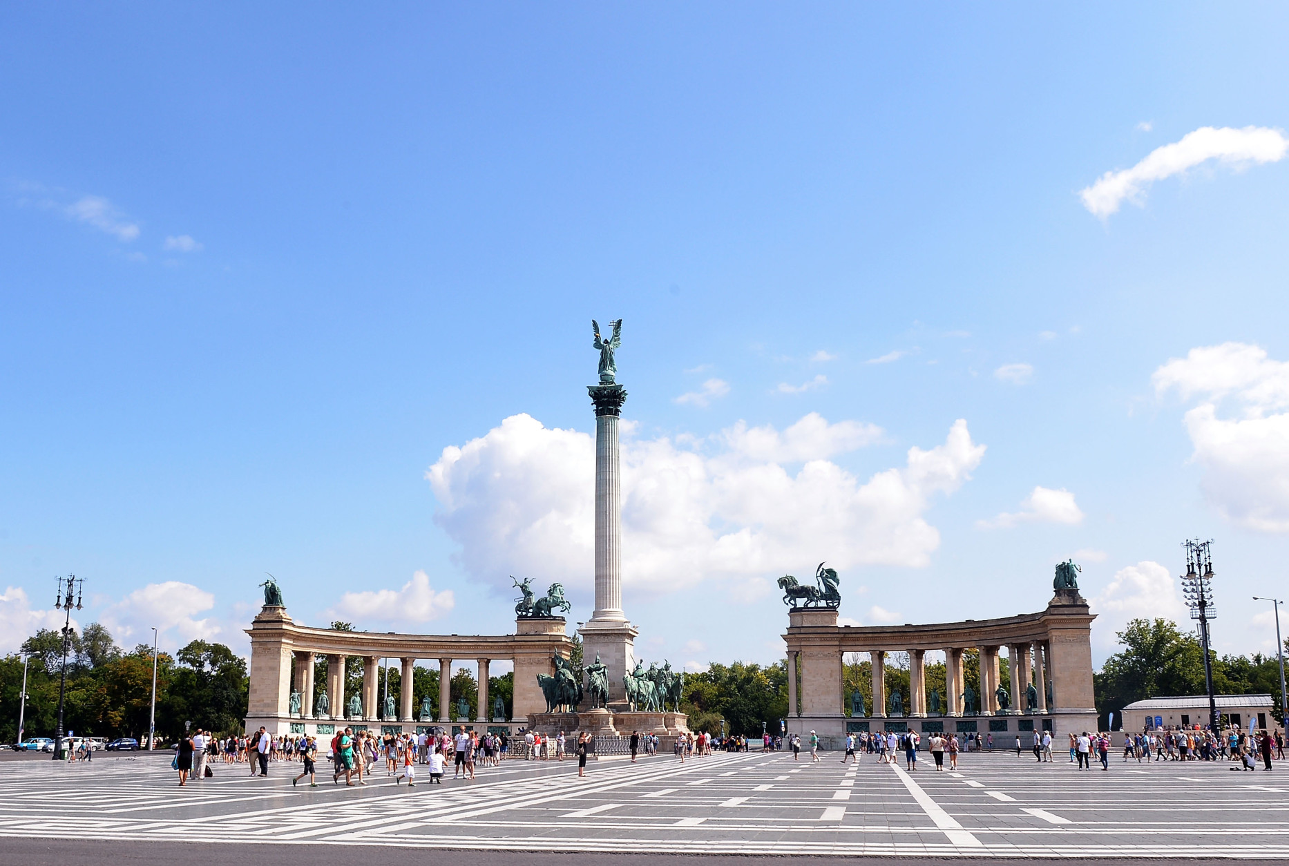 BUDAPEST, HUNGARY - JULY 24:  Tourists and locals walk across Heroes' Square past Millenium Monument during previews ahead of the Hungarian Formula One Grand Prix on July 24, 2014 in Budapest, Hungary.  (Photo by Lars Baron/Getty Images)