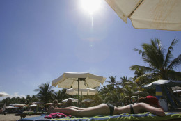 KUTA BEACH BALI, INDONESIA - MAY 24: A tourist sunbathes on Kuta Beach on May 24, 2005 in Bali, Indonesia. Australian travel agents have threatened to stop promoting Bali as a destination if accused Australian drug smuggler Schapelle Corby is found guilty by the Indonesian courts in May 27 verdict. Corby is facing the maximum penalty of death by firing squad after drugs were found inside her unlocked bag at Bali airport in October 2004. (Photo by Dimas Ardian/Getty Images)