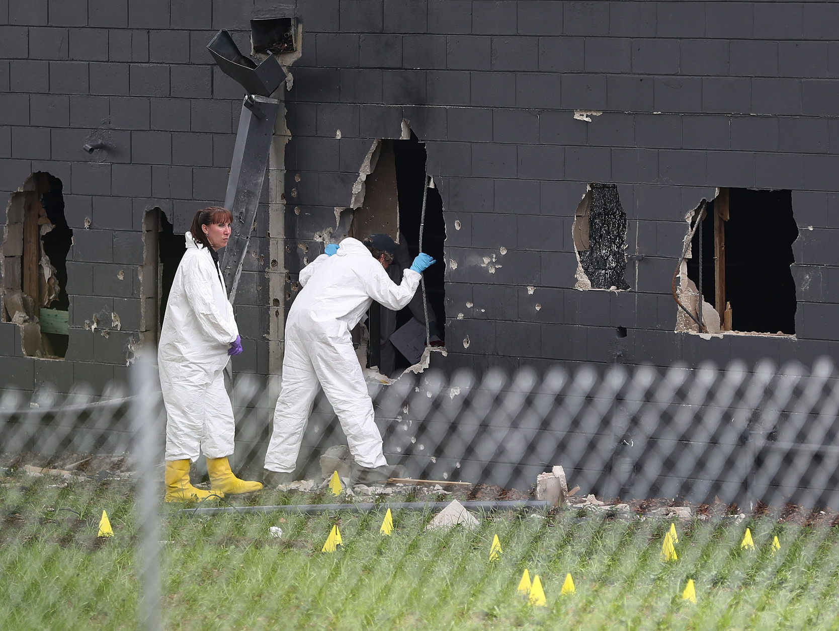 ORLANDO, FL - JUNE 12:  FBI agents investigate near the damaged rear wall of the Pulse Nightclub where Omar Mateen allegedly killed at least 50 people on June 12, 2016 in Orlando, Florida. The mass shooting killed at least 50 people and injuring 53 others in what is the deadliest mass shooting in the country's history.  (Photo by Joe Raedle/Getty Images)