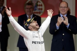 Mercedes driver Lewis Hamilton of Britain celebrates on the podium after winning the Monaco Formula One Grand Prix in Monaco, Sunday, May 29, 2016. (AP Photo/Petr David Josek)